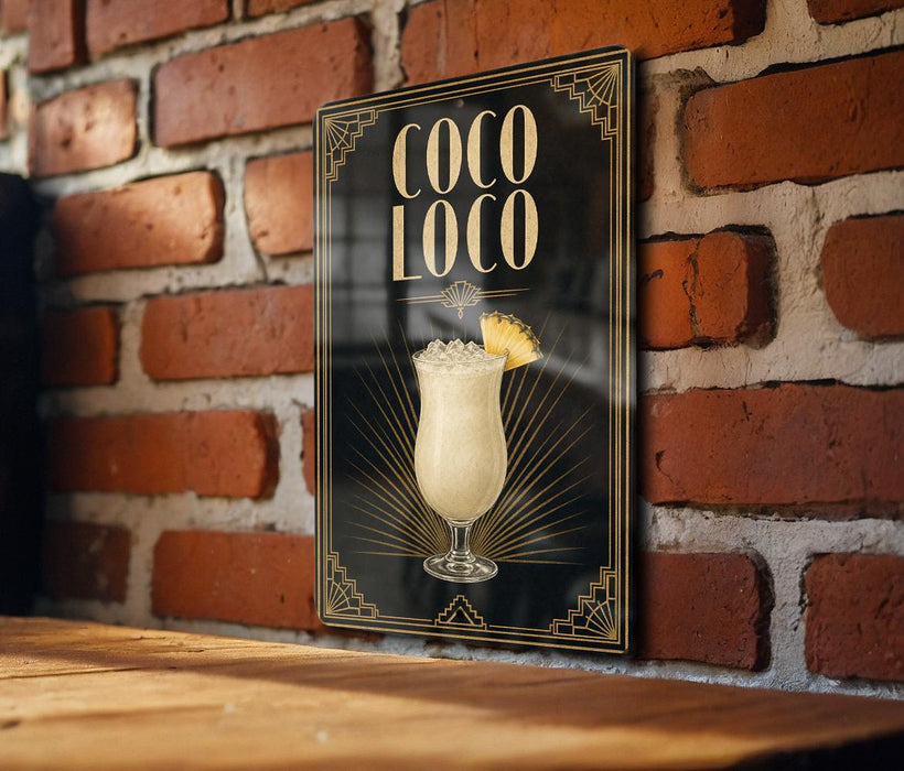 A poster or sign for a cocktail called "Coco Loco" is displayed on a brick wall.