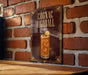 A sign for a cocktail called "Cognac Highball" is displayed on a brick wall.