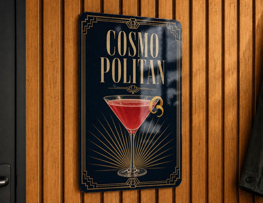 A sign for a cocktail called "Cosmo Politan" is displayed on a wooden wall.
