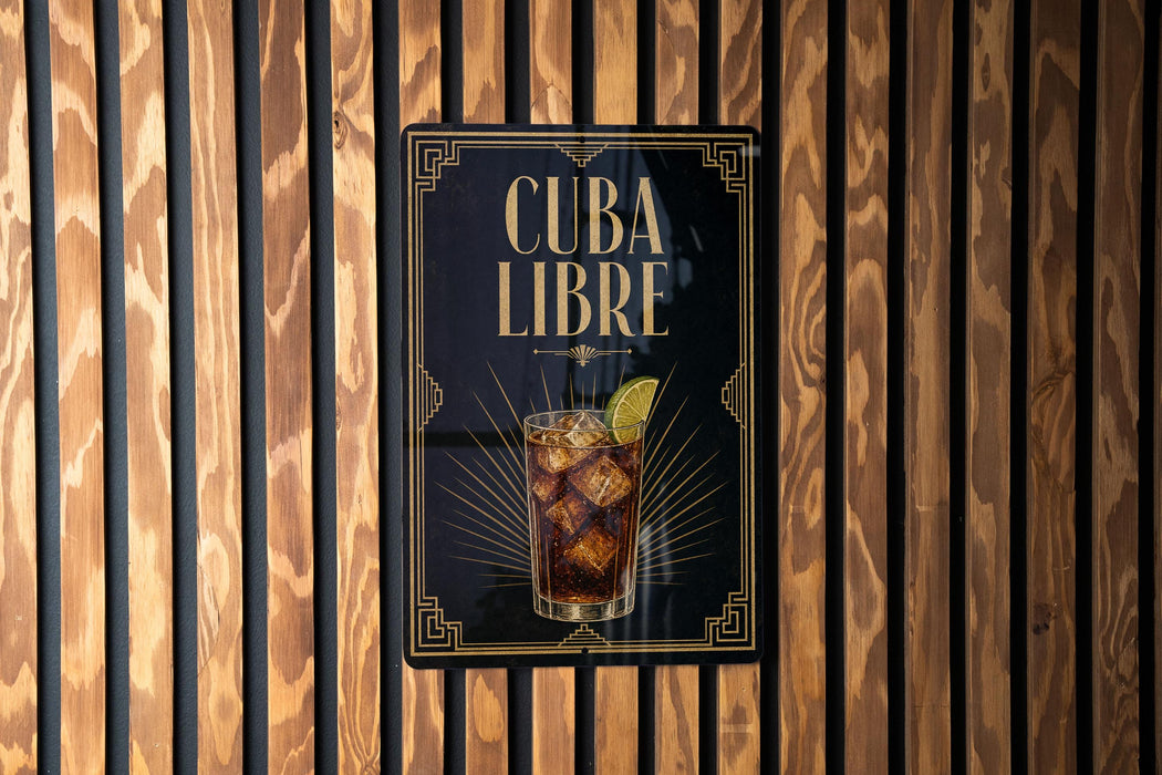 a sign with the text "CUBA LIBRE" and an illustration of a drink, likely a cocktail, with a lime garnish.