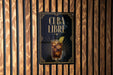 a sign with the text "CUBA LIBRE" and an illustration of a drink, likely a cocktail, with a lime garnish.
