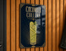 A sign for "Cucumber Collins" cocktail, featuring a stylized illustration of a cucumber and a glass of the drink.