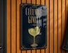 a sign with the text "Cucumber Gimlet" and an illustration of a glass containing a cucumber drink.