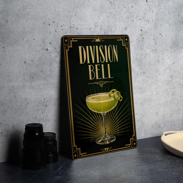 a framed illustration of a cocktail glass with a lime on a black background, accompanied by the text "DIVISION BELL" in a decorative font.