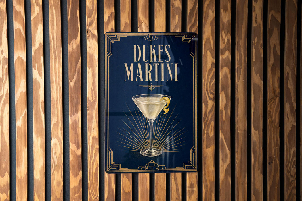 A sign for Dukes Martini is displayed on a wooden wall.