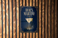A sign for Dukes Martini is displayed on a wooden wall.