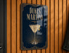 A sign for "DUKE'S MARTINI" is displayed on a wooden wall, featuring an illustration of a martini glass with a lemon twist.