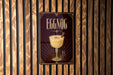A poster advertising "Eggnog" cocktail is displayed on a wooden wall.