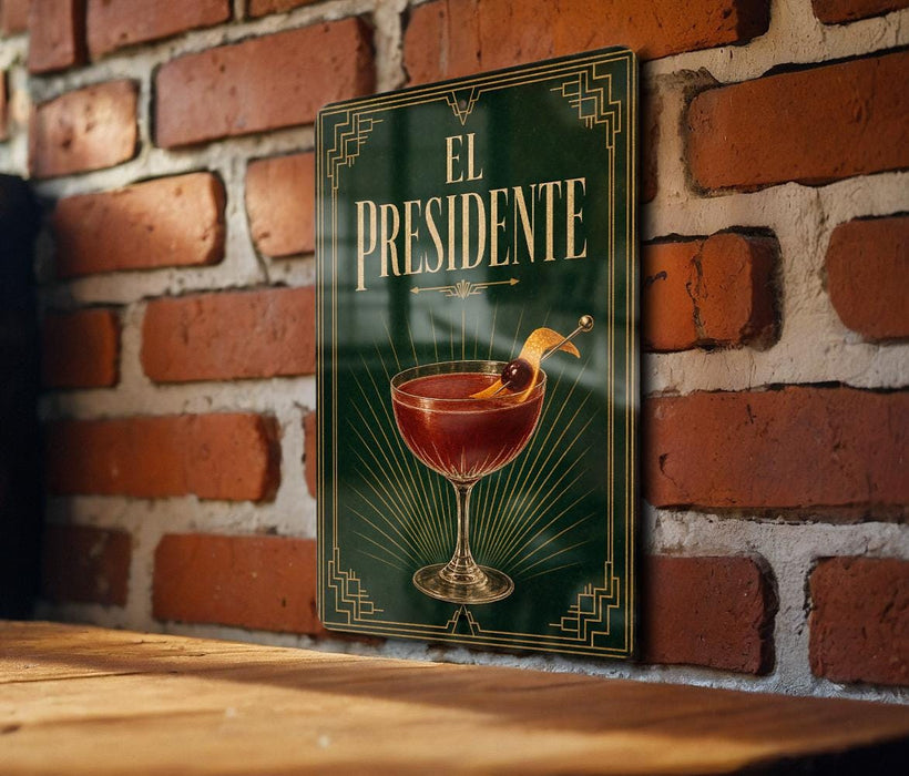 a sign with the text "EL PRESIDENTE" and an illustration of a cocktail glass with a lemon peel.