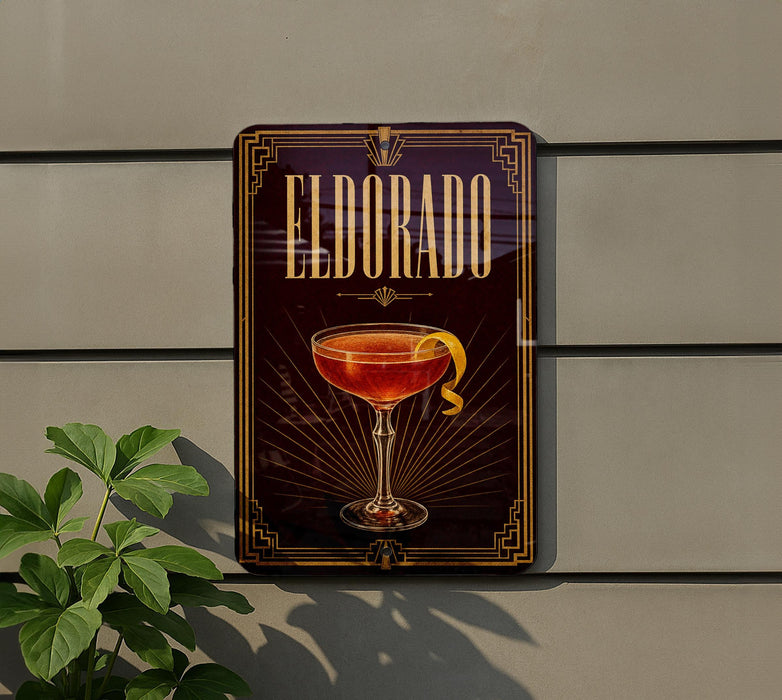 A decorative sign for "Eldorado" cocktail, featuring a glass of the drink with a lemon twist, is displayed on a wall.