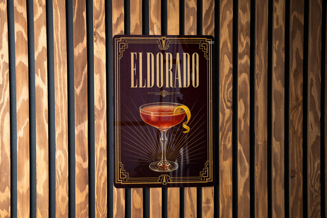 A sign for "Eldorado" cocktail is displayed on a wooden wall.