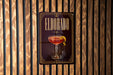 A sign for "Eldorado" cocktail is displayed on a wooden wall.