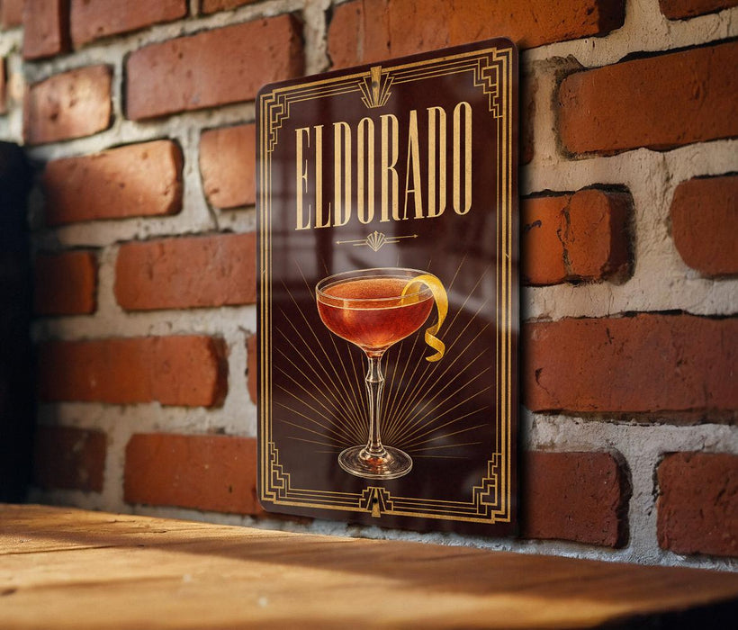 A framed poster of a cocktail called "Eldorado" is displayed on a brick wall.