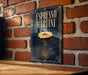 A poster or sign for "Espresso Martini" is displayed on a brick wall, featuring an illustration of a martini glass with a frothy head and coffee beans.
