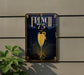 a sign for "French 75" with a glass of champagne, and there is a plant to the left of the sign.