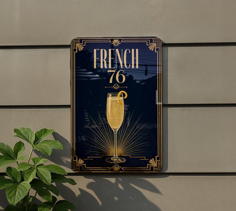 a sign with the word "FRENCH" and a glass of champagne, along with a decorative border and a sunburst design.