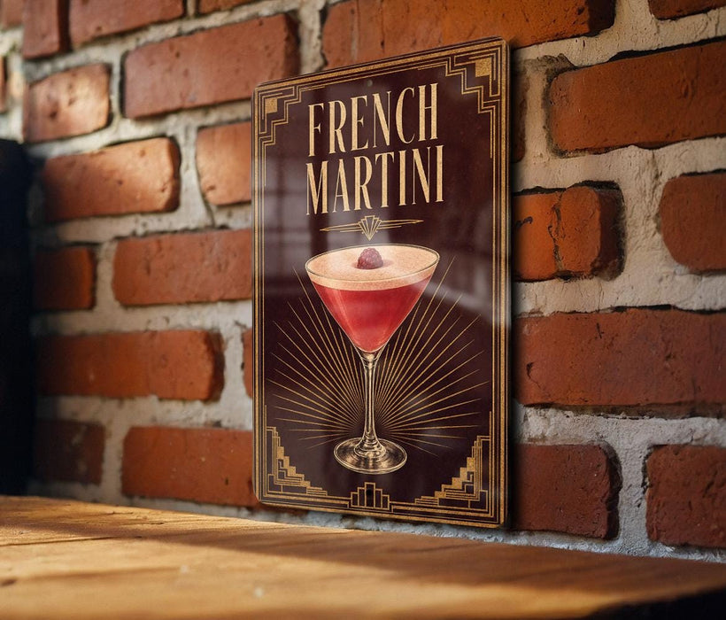 A framed poster of a French martini is displayed on a brick wall.