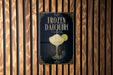 A poster advertising a frozen daiquiri, featuring a glass of the cocktail with a lime wedge.