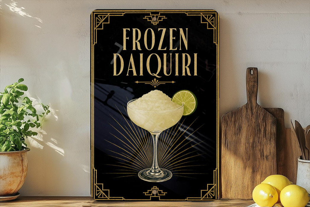 A framed advertisement for a frozen daiquiri cocktail, featuring a glass of the drink and a lime slice, is displayed on a wall next to a wooden cutting board and a potted plant.