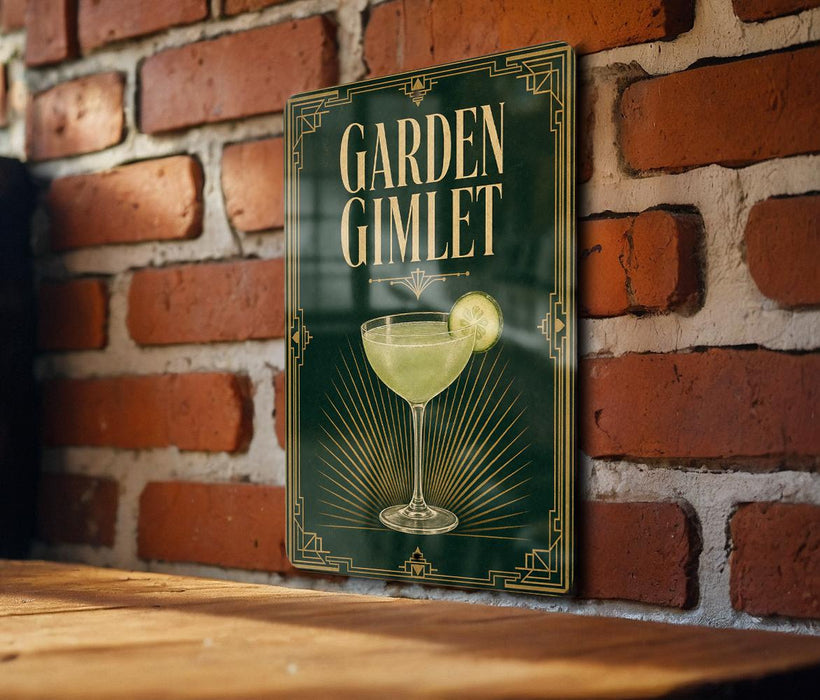 A sign with the text "GARDEN GIMLET" and an illustration of a cocktail glass with a lime slice, mounted on a brick wall.