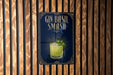 A sign for a gin smash cocktail is displayed on a wooden wall.