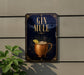 A sign for a gin mule, featuring a copper mug with a lemon slice, is displayed on a wall.