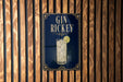 A sign for " Gin Rickey" is displayed on a wooden wall.