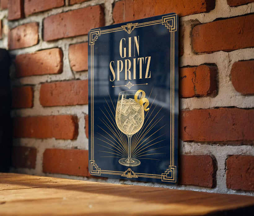 A sign with the text "GIN SPRITZ" and an illustration of a gin and tonic drink is displayed on a brick wall.
