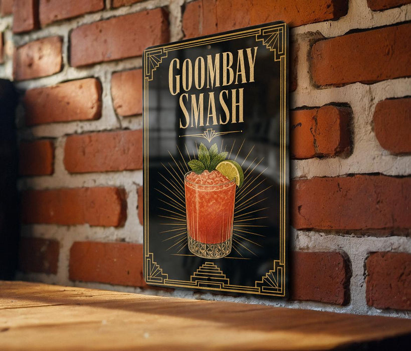 A framed poster of a cocktail called "Goombay Smash" is displayed on a brick wall.