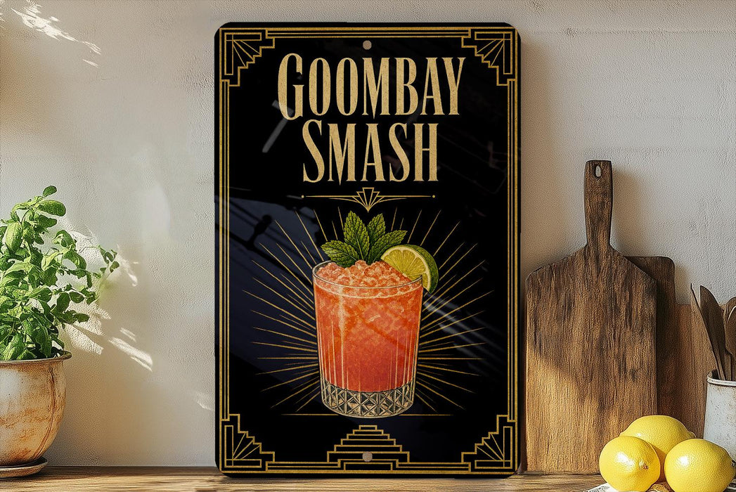 A black sign with gold trim displaying the text "GOOMBAY SMASH" and an illustration of a cocktail with a lemon slice.