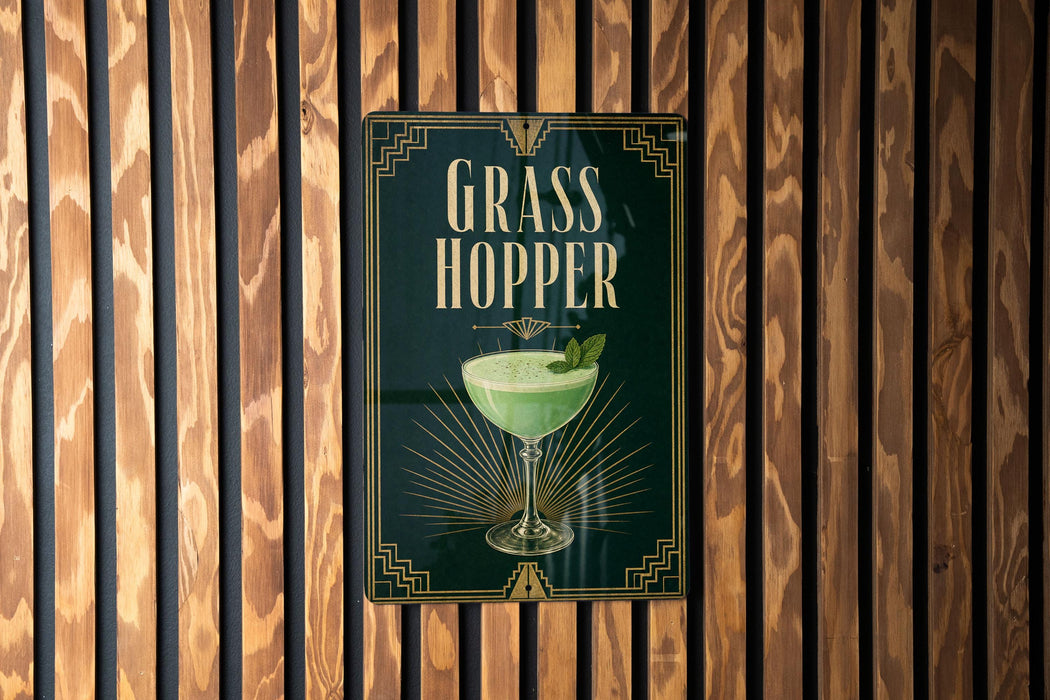 A sign for a "Grass Hopper" cocktail is displayed on a wooden wall.