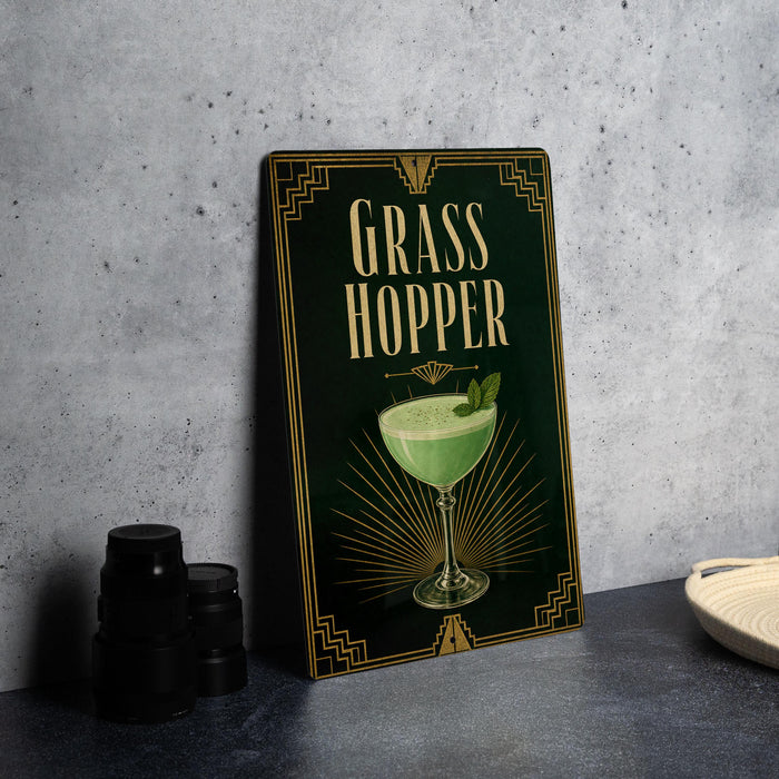 A framed poster or menu for a "Grass Hopper" cocktail, featuring an illustration of a green drink in a glass with a garnish.