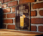 A sign for "Harvey Wallbanger" cocktail is displayed on a brick wall, featuring an illustration of a glass with a slice of orange.