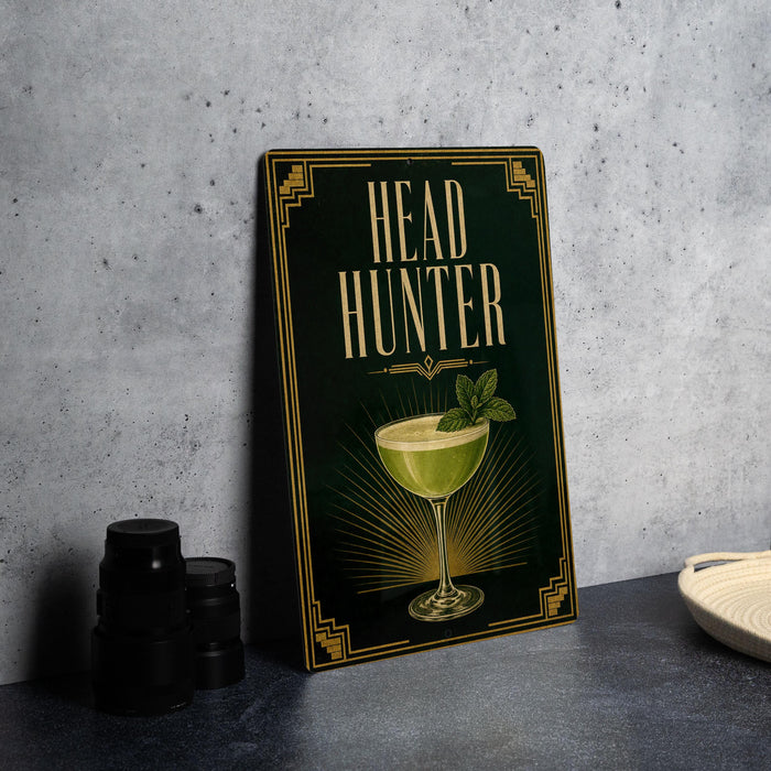 a framed poster with the title "HEAD HUNTER" on it, along with an illustration of a cocktail glass.