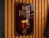 A sign that reads "HOT ITALAN" with an illustration of a hot beverage, likely a cocktail or hot drink, on a wooden wall.