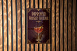 a sign that reads "IMPROVED WHISKEY COCKTAIL" with an illustration of a cocktail on the sign.