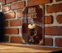 A vintage-style poster advertising Irish coffee is displayed on a brick wall.
