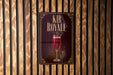 a sign for "Kir Royale", which is a cocktail, hanging on a wooden wall.