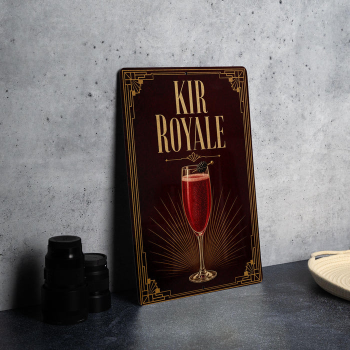 a decorative sign with the text "KIR ROYALE" and an illustration of a glass of red wine.