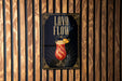 A sign for a lava flow cocktail, featuring a stylized illustration of a red drink with a pineapple garnish.