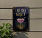 a sign for a lavender gimlet cocktail, which is a purple drink with a garnish, placed on a wall.