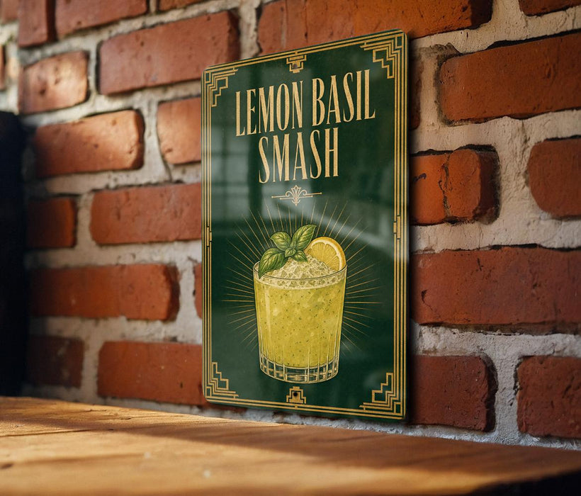 A framed poster of a lemon basil smash cocktail is displayed on a brick wall.