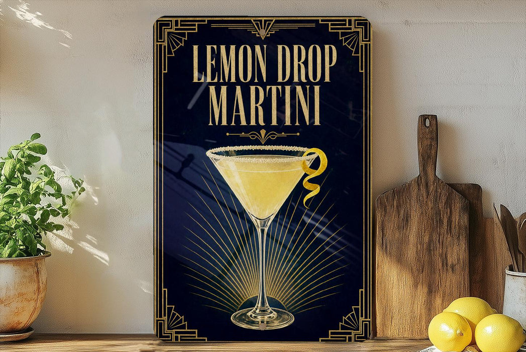 A framed advertisement for a lemon drop martini, featuring a glass of the cocktail with a lemon twist on the rim.