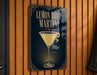 A sign for a lemon drop martini, featuring an illustration of a martini glass with a lemon twist.