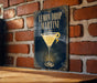 A sign with the text "Lemon Drop Martini" and an illustration of a martini glass with a lemon twist.