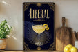 A framed poster with the word "LIBERAL" prominently displayed, featuring an illustration of a cocktail glass with a lemon twist.