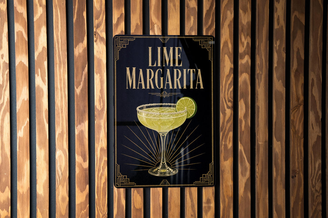 A sign for a lime margarita is displayed on a wooden wall.