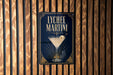 A sign for Lychee Martini, featuring a martini glass with a slice of lychee fruit, is displayed on a wooden wall.