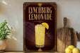A sign for Lynchburg Lemonade is displayed on a shelf, featuring an illustration of a tall glass filled with lemonade and a lemon slice.