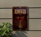 A decorative sign for "Manhattan" cocktail, featuring a glass of Manhattan cocktail with a straw and garnish.